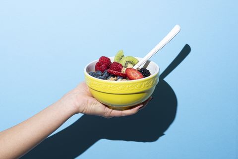 woman's hand holding bowl with muesli
