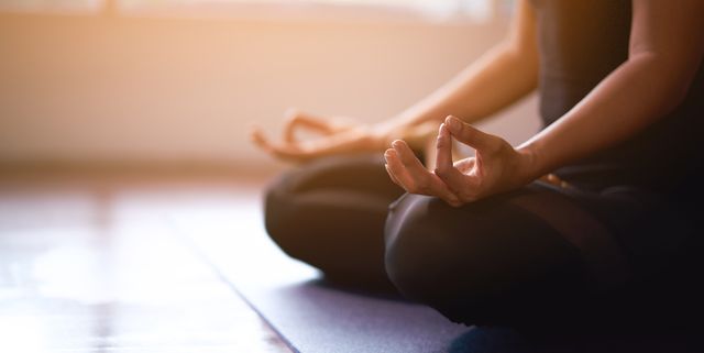 women in meditation while practicing yoga in a training room happy, calm and relaxing