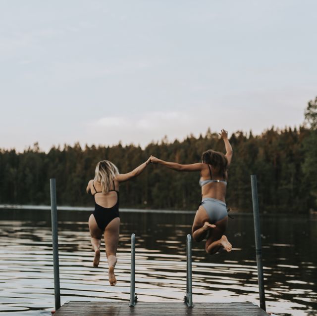 women jumping in the water