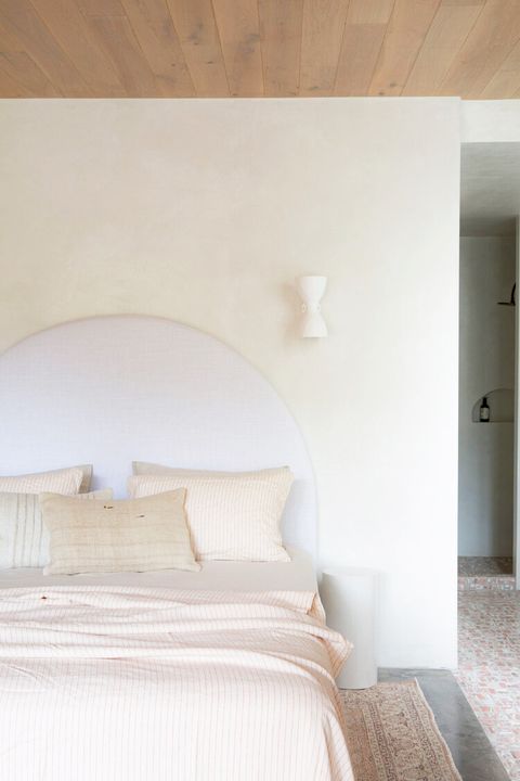 light pink and white bedroom with wood ceiling