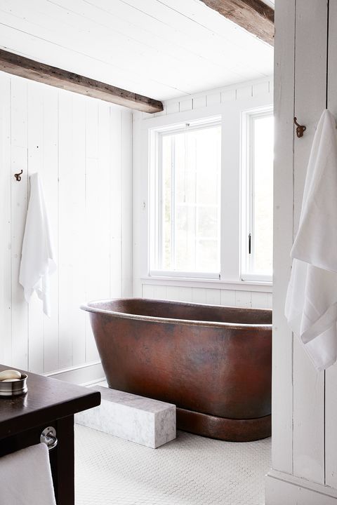 modern white farmhouse bathroom with copper bathtub