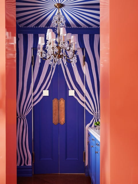 blue and white cabana striped tenting drapes the bar and its slim swinging doors