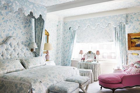 in the roses' bedroom, an antique chaise in a deep azalea shade scala­mandré is a vivid foil for quadrille's pastel print dressing the walls, windows, and bed