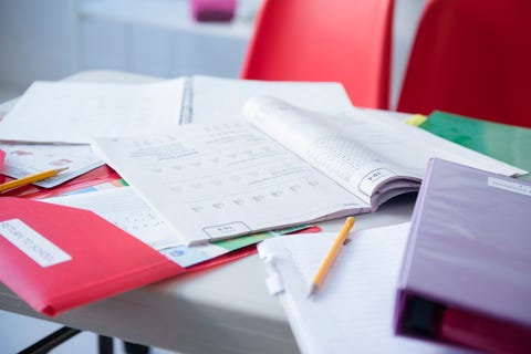 Workbook and folder on desk in classroom Workbook and folder on desk in classroom