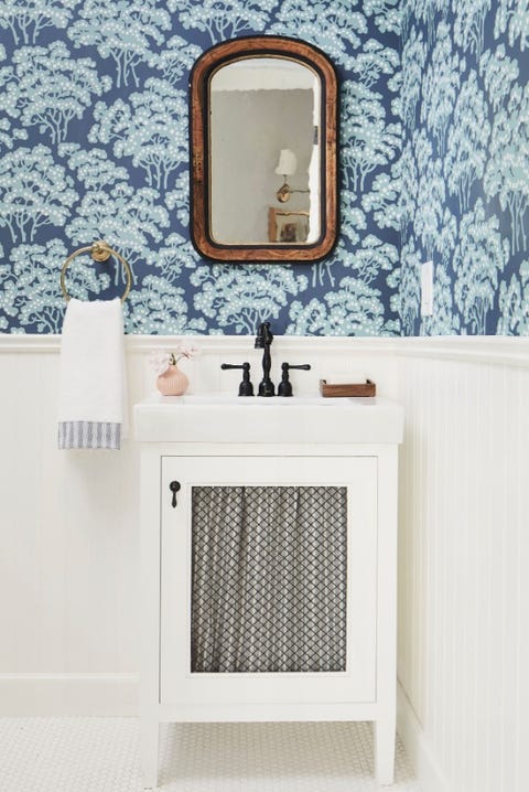 blue flower wallpaper with white toilet and sink