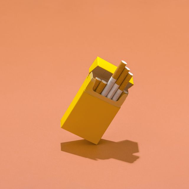 yellow cigarette pack on coral colored background
