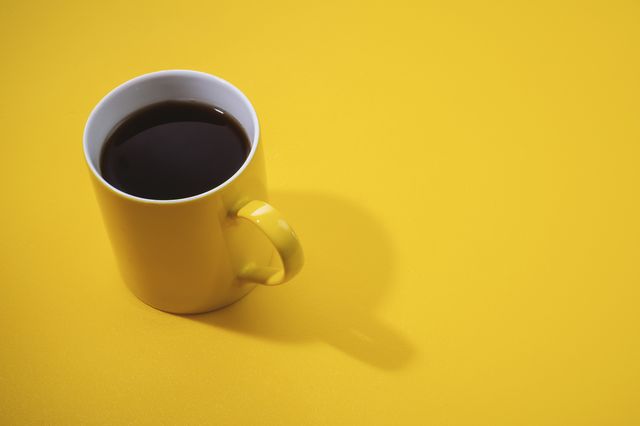 yellow coffee mug on yellow background