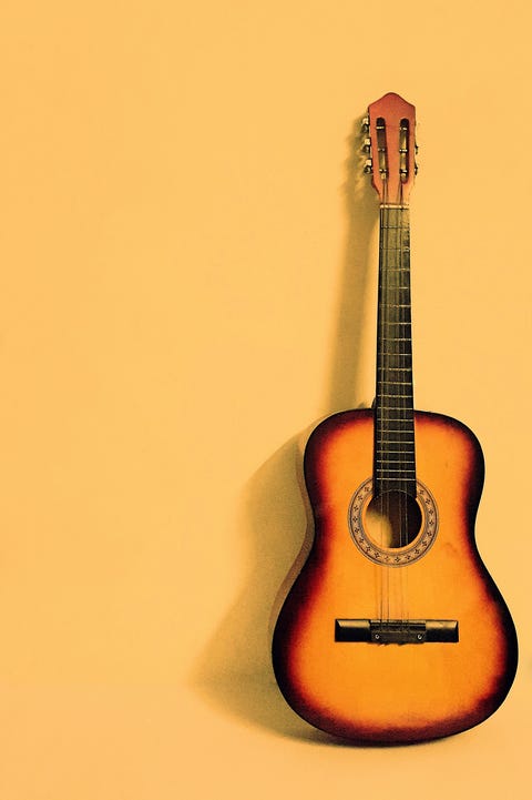 Yellow Guitar Against Yellow Background Yellow Guitar Against Yellow Background
