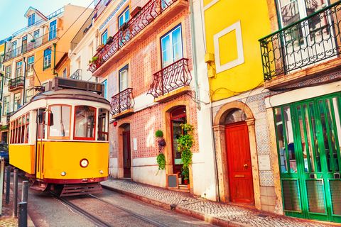 yellow vintage tram on the street in lisbon portugal