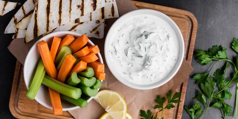 Yogurt sauce with parsley served with fresh carrot and celery sticks