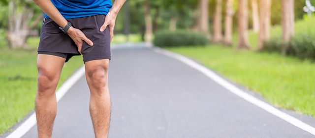 young adult male with muscle pain during running runner have leg ache due to groin pull sports injuries and medical concept