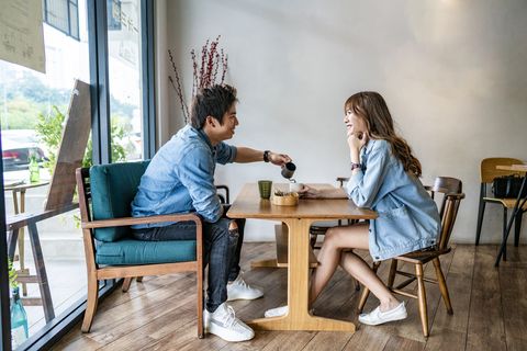 young asian couple drinking coffee at cafe coffee shop