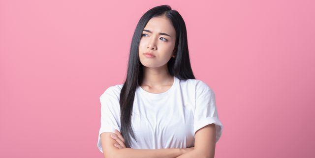 young asian woman get bored, upset, look at copy space, isolated on pink background pretty girl gesturing on face like a bad mood, unhappy, touchy, bored something she look upward, feel annoyed
