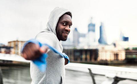 Young Black Sportsman Exercising With Elastic Rubber Bands In London