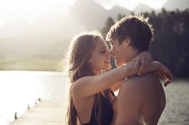 young couple about to kiss in a natural environmen