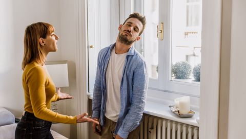 young couple arguing while standing at home