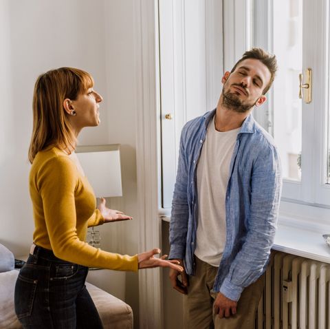 young couple arguing while standing at home