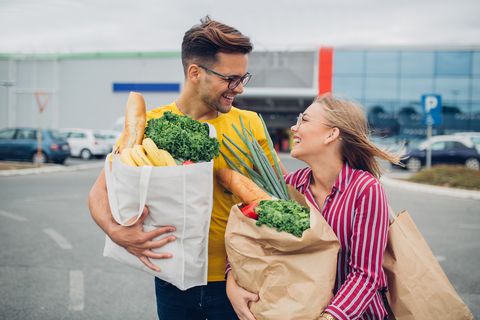 young couple at grocery shopping with reusable bag