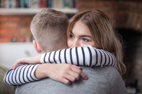 young couple hugging, indoors, close up