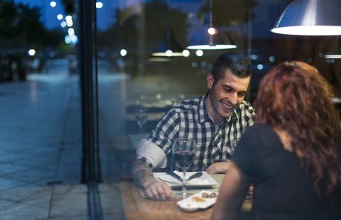 Young couple in modern restaurant having dinner