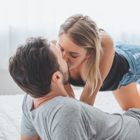 Young Couple Kissing On Bed