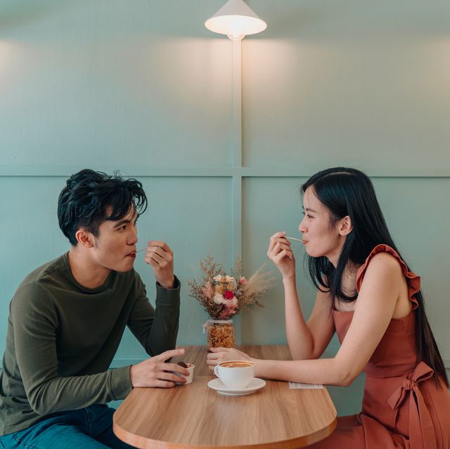 young couple locking eyes in a cafe