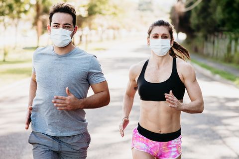 young couple woman and man are jogging and exciseing outdoor in city