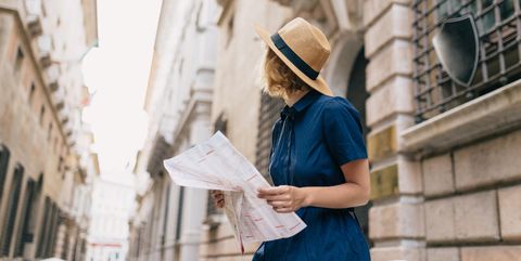 Young female tourist holding map
