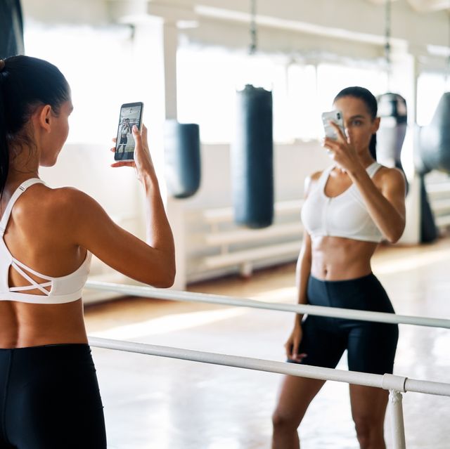young fit woman making a selfie in gym after exercise