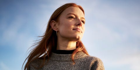 Young lady looking content in the winter sunshine
