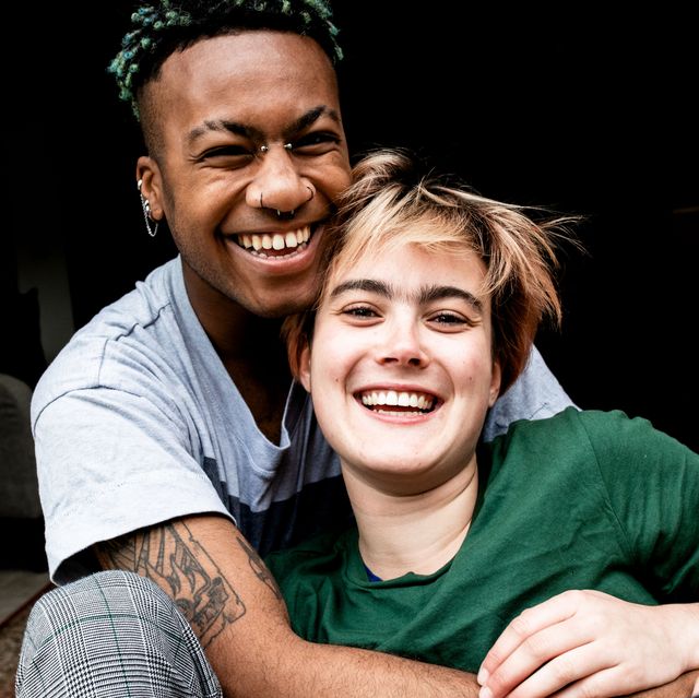 a young lgbt couple laughing and hugging