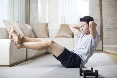 Young man exercising at home