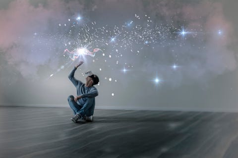 Young man in empty apartment sitting on the floor using Virtual Reality Glasses, composite