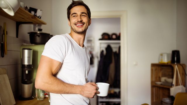 young man in kitchen with coffee