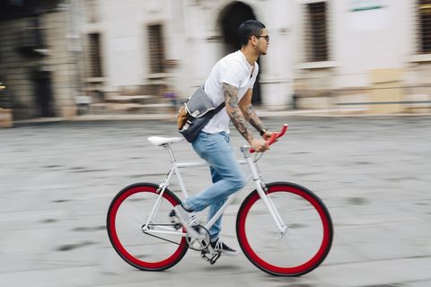 Young man riding bicycle in the city