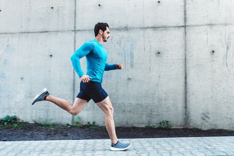 Young man running outdoors in morning