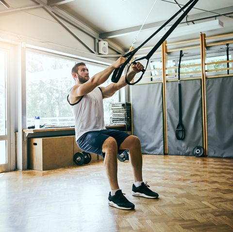Young man workout with TRX Suspension