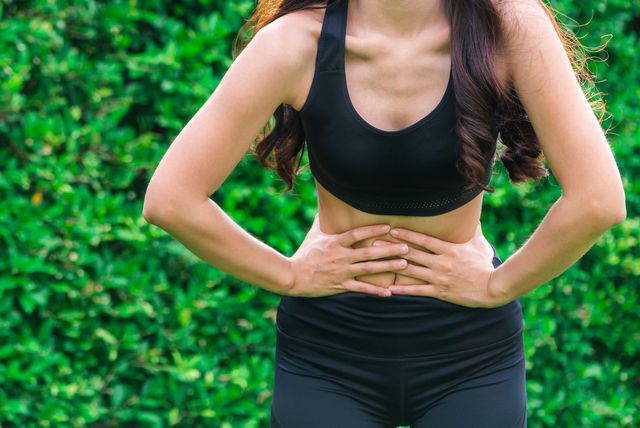 young sport woman having pain at her stomach