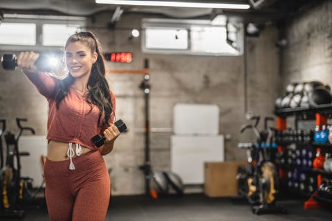 Young sporty woman is having weight training with dumbbells at the gym young sporty woman is having weight training with dumbbells at the gym