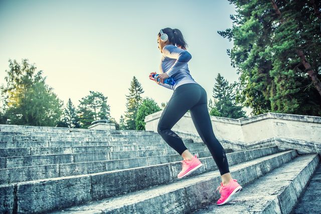 young woman doing sports and running up the stairs