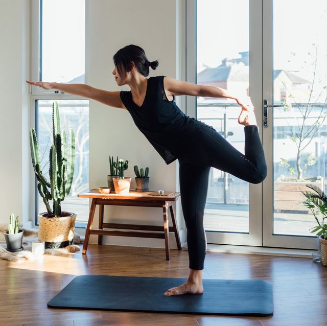 Young woman doing yoga exercise at home