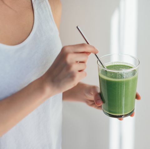 young woman drinking green juice for cleanse diet