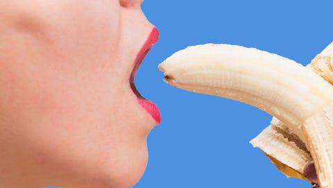 Young woman eating a banana