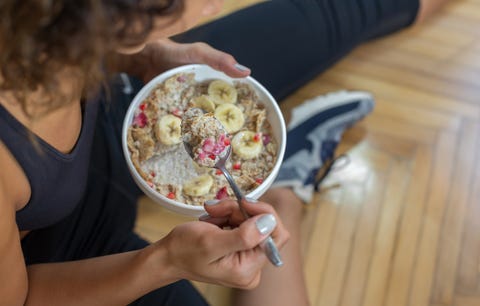 Young woman eating a oatmeal after a workout