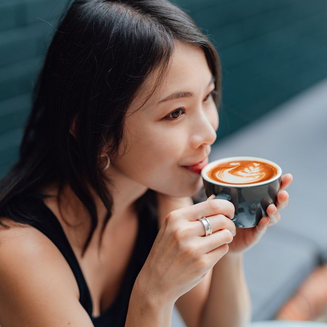 young woman enjoying a peaceful morning with a cup of coffee in cafe