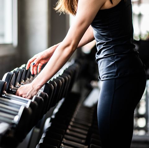 Young Woman Exercising In Gym
