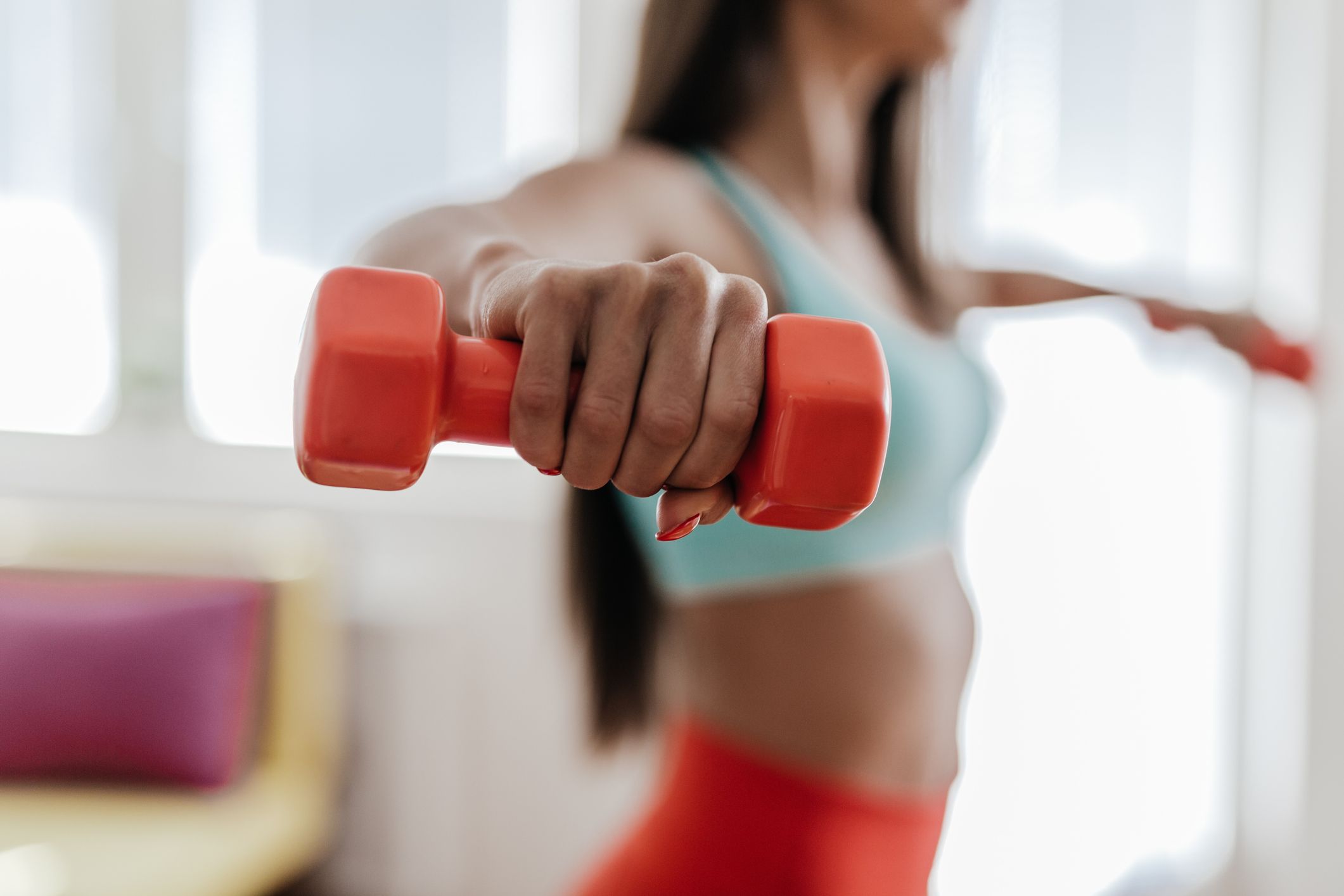 young woman exercising with her weights in the royalty free image 1640822809