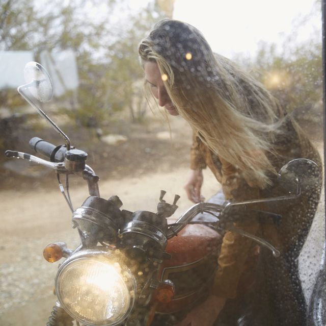 young woman getting ready for motorcycle ride
