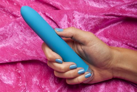 Young Woman Holding Vibrator