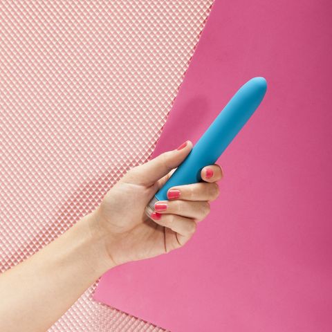 Young Woman Holding Vibrator